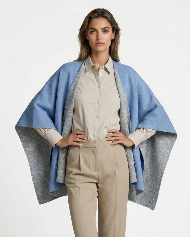 Junge Dame trägt ein hellblaues Strickcape aus Italien